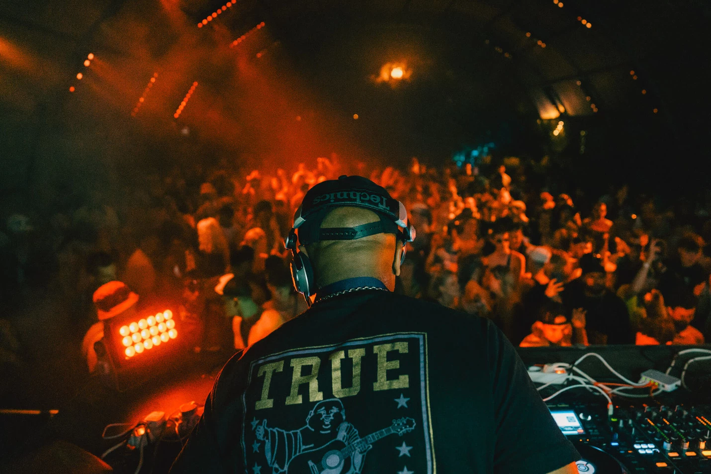 Image of DJ in front of crowd at Outlook Origins Festival