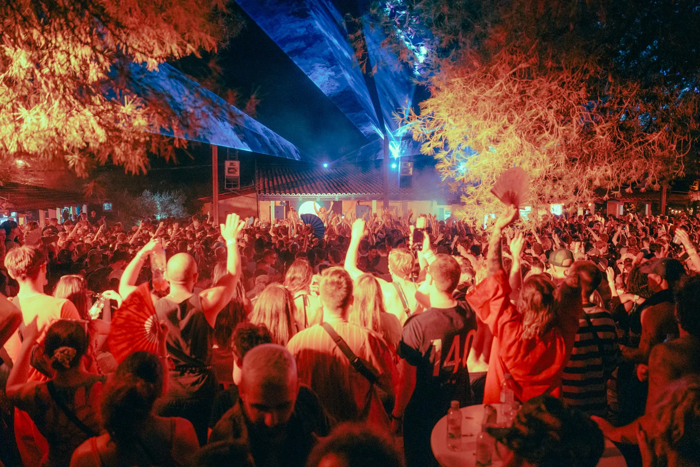 Image of packed crowd with arms in the air in front of stage at Outlook Origins Festival