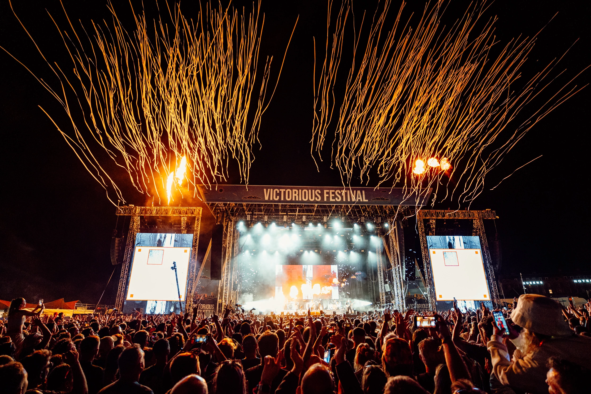 Confetti cannons bursting in front of a live performance at Victorious Festival
