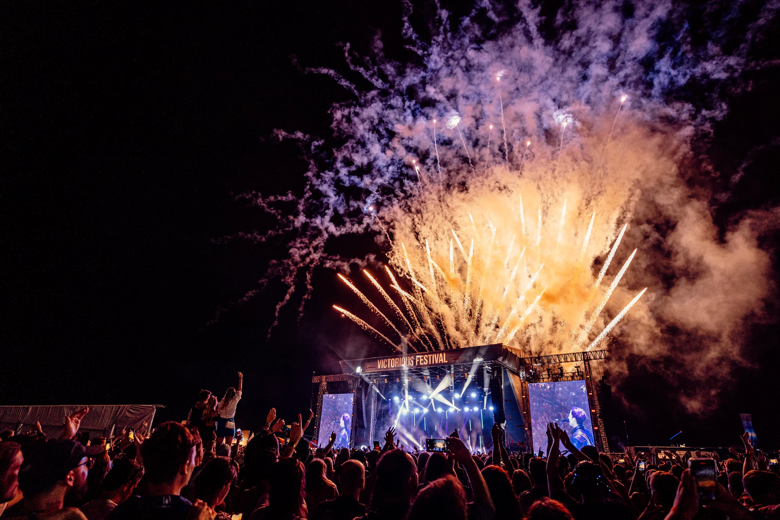 Image of fireworks behind a stage at Victorious Festival